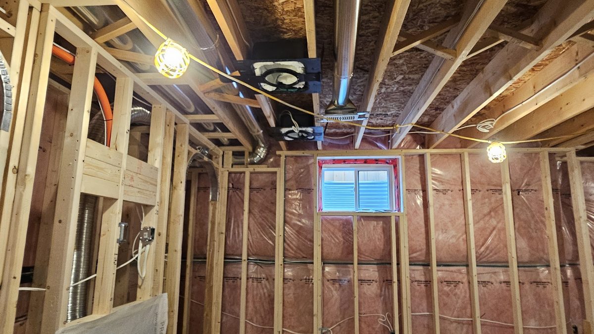 Low-voltage wiring and ceiling back boxes in open framing at rough-in, before drywall